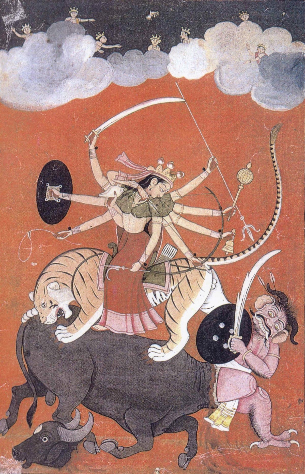 A painting of Durga on her lion driving a spear into the buffalo demon