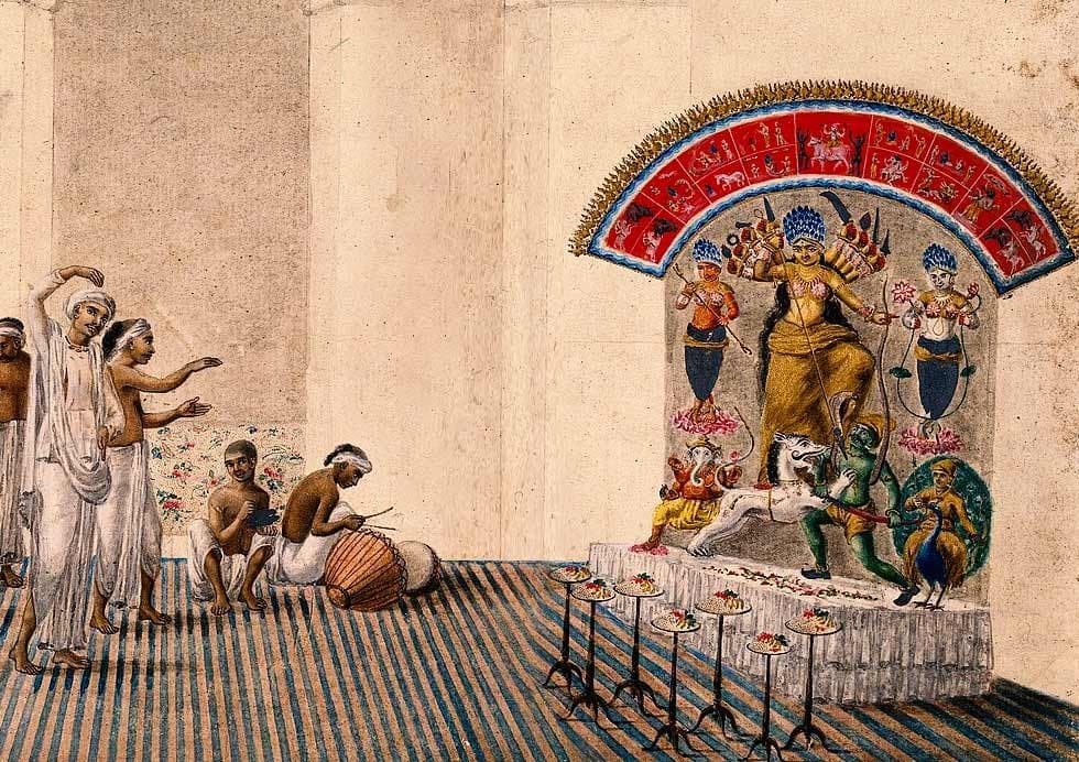 Priests at work in a pillared thakur dalan during the Puja