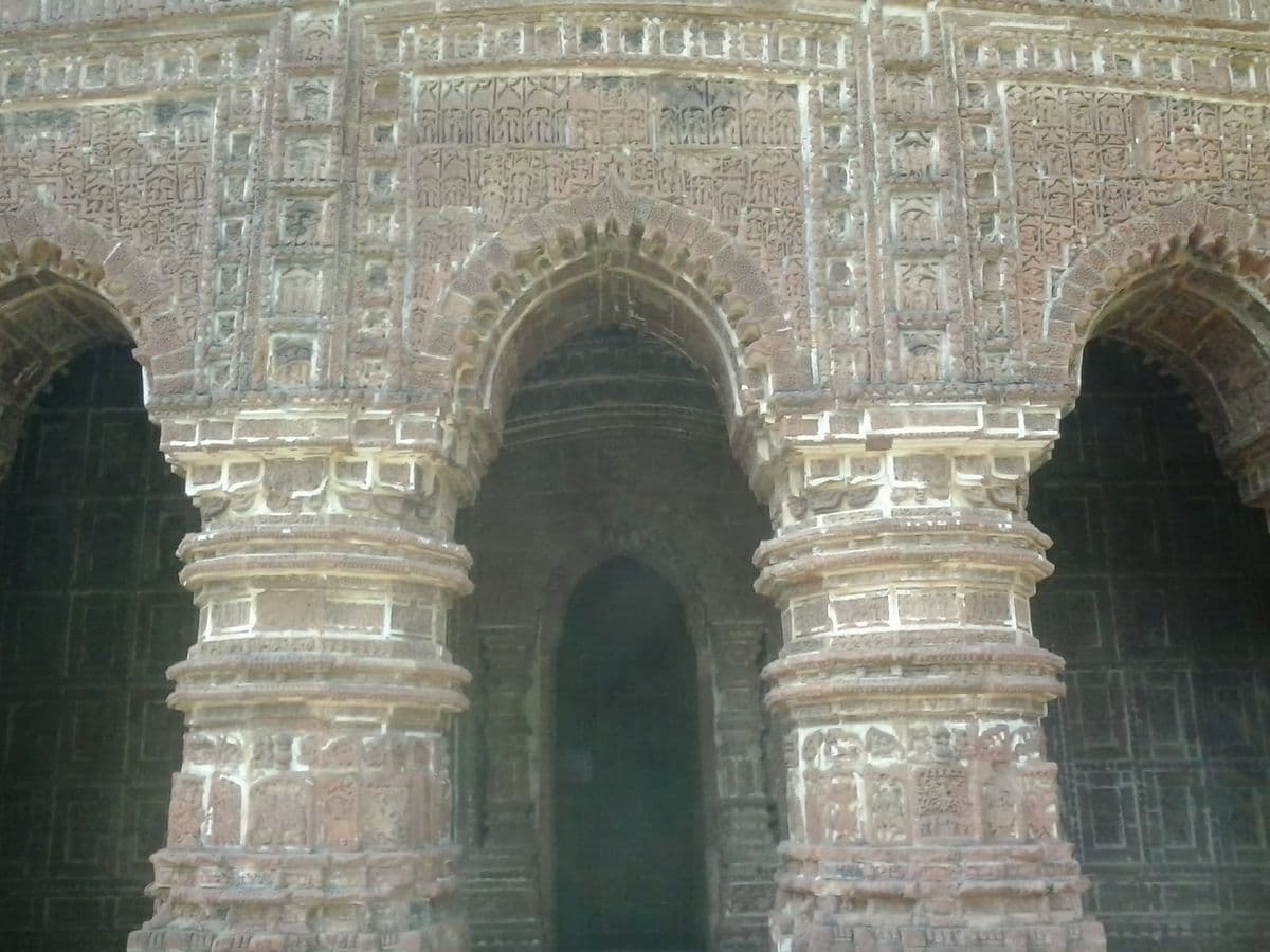 Terracotta reliefs on the Kalachand temple at Bishnupur, where the fired plaque is both ornament and structural facing.