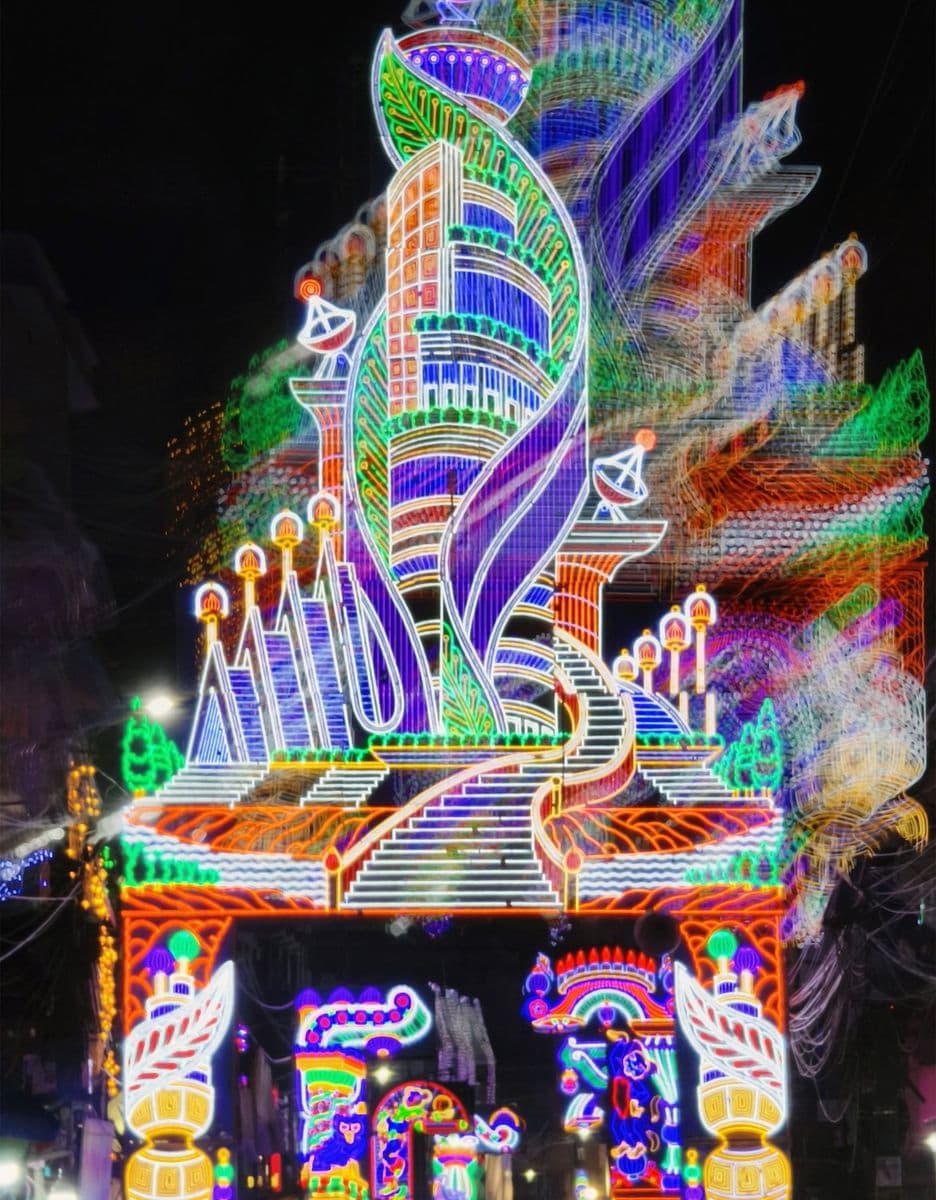 A Chandannagar light gate, 2024, with the figurative panel work that the town's firms build for pujas across India.
