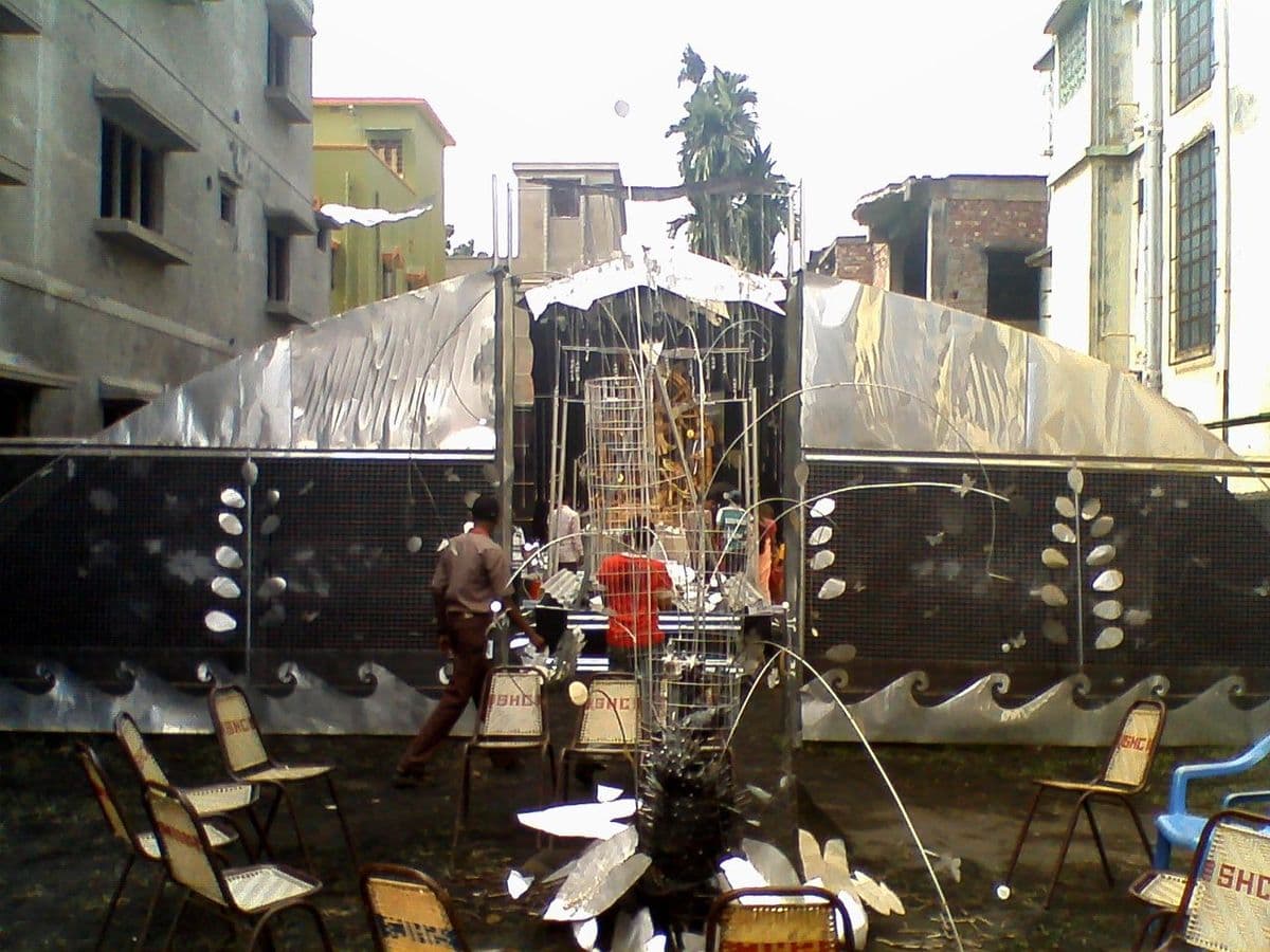 A pandal clad entirely in sheet metal, 2012: the annual materials experiment that the theme puja format makes possible.